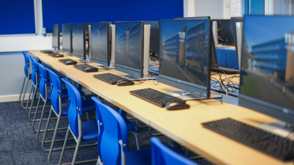 Close-up of computer screens set up on Sienna Evolution Bench Desks in the IT Suite.