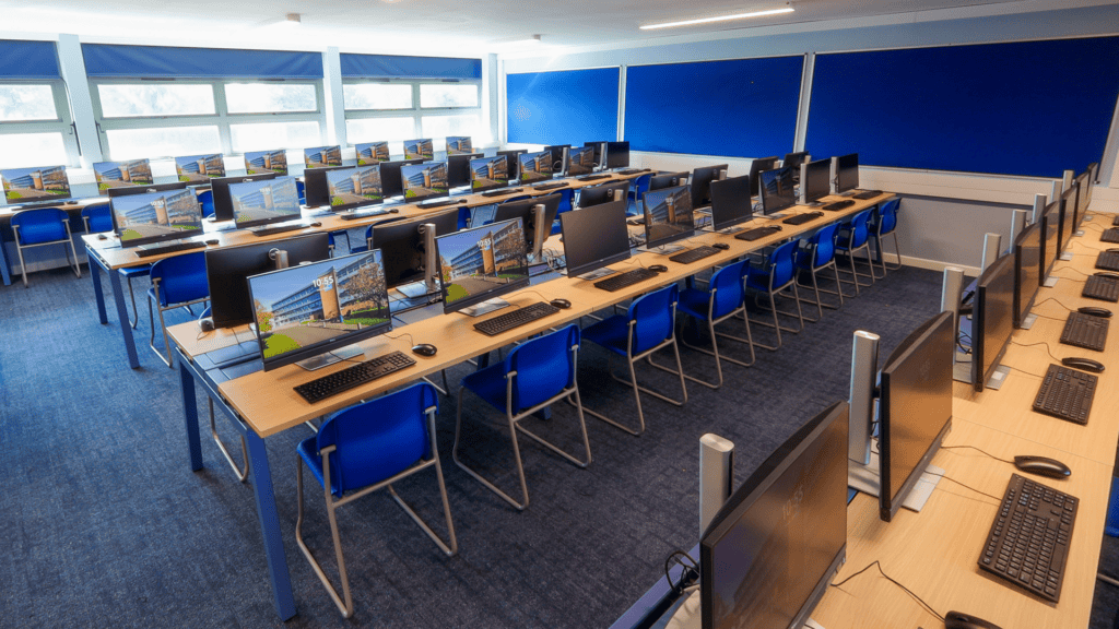 Wide shot of the fully transformed IT classroom featuring Sienna Evolution Bench Desks and Storm Skid Base Chairs.