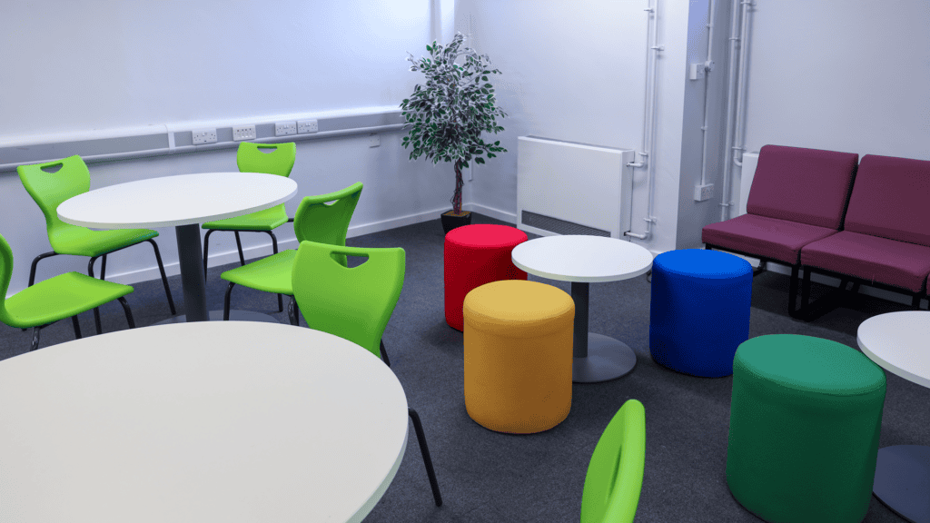 Common room at Colton Hills showcasing Sixth Form spaces with soft seating and workstations.